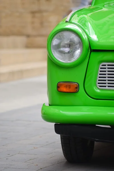 Head light of a East-German plastic vintage car. Green Trabant — Stock Photo, Image