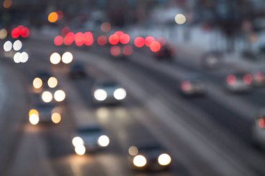 Blurred traffic on asphalt road in city with white and read bokeh lights on cars