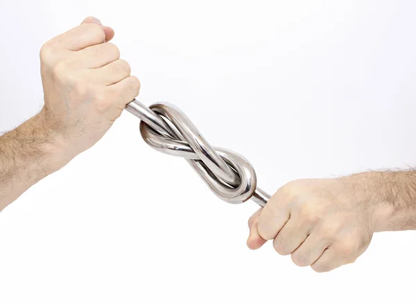 Strong knot of a metal rod in male hands — Stock Photo, Image