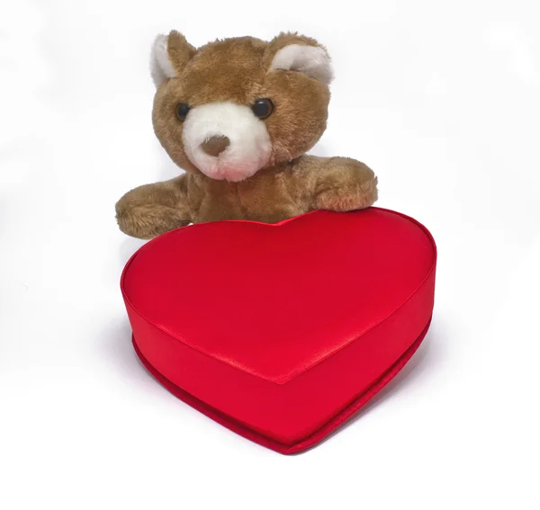 Teddy bear with gift box in heart shape — Stock Photo, Image