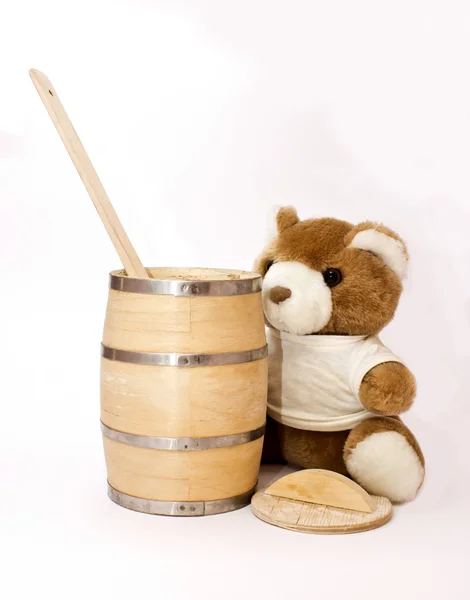 Teddy bear with the keg of honey and a big wooden spoon — Stock Photo, Image