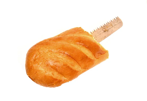 Saw blade hidden in a loaf of bread isolated — Stock Photo, Image
