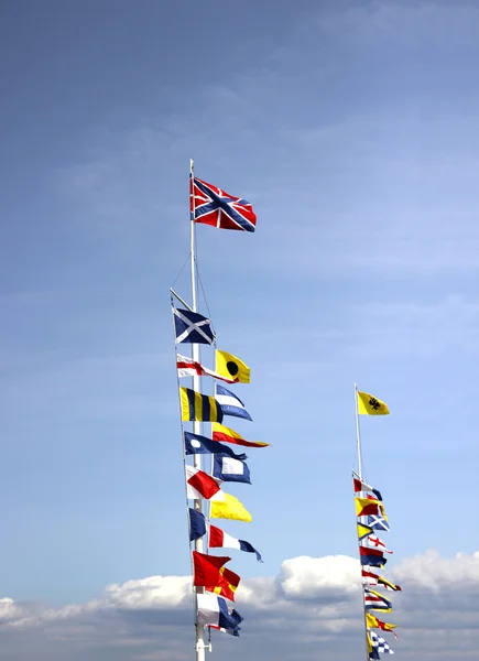 Marine flags of different countries on a mast — Stock Photo, Image