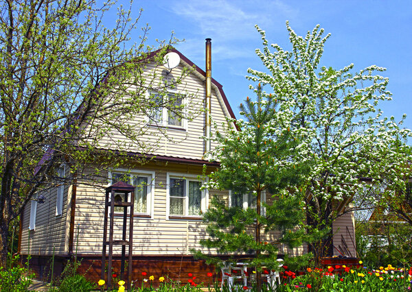 Garden house surrounded by blossoming trees