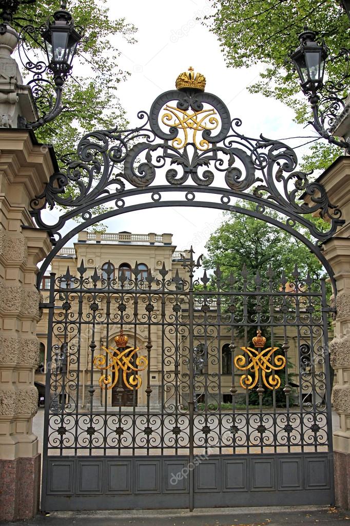 Openwork gate with the royal monogram in St. Petersburg, Russia