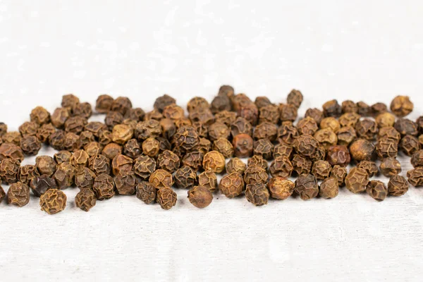 Lot Whole Spicy Black Pepper White Background Placed Horizontally — Stock Photo, Image