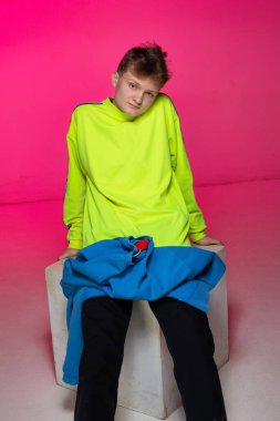 Beyaz tenli, pembe tenli, sarışın, oturan genç Avrupalı çocuk.