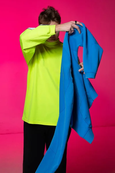 Young European Boy White Skin Isolated Pink Holding Blue Hoody — Stock fotografie