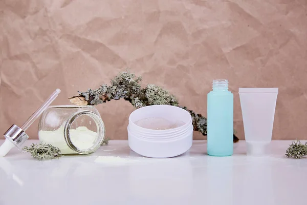 Organic mock up face care cosmetics. Wellbeing serum, alginate mask and patches: multitasking beauty products. Scinimalism concept, polytasking functions. Natural eco forest moss. Dermatology cosmetics