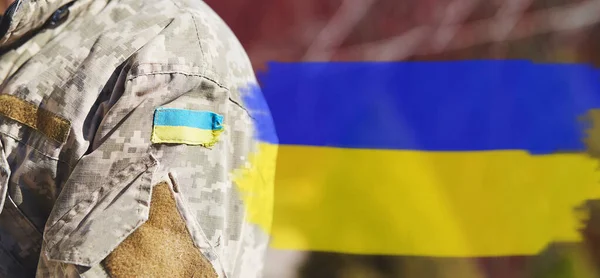 Ukrainian flag on military uniform. Ukrainian flag with copy space. Stop Russian aggression. Stop the war in Ukraine. Stay with Ukraine. Sensation. Pray for Ukraine