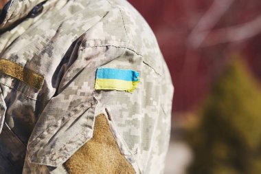 Askeri üniformanın üzerinde Ukrayna bayrağı var. Rus saldırısını durdurun. Ukrayna 'daki savaşı durdurun. Ukrayna 'da kal. Son dakika haberi. Ukrayna için dua et. Boşluğu kopyala.