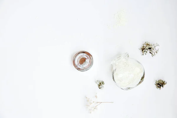 Natural wellness face care cosmetic on white background. Alginate mask. Organic forest moss. Hyaluronic and moisturizing cosmetic. Dermatology natural products . Top view, copy space.