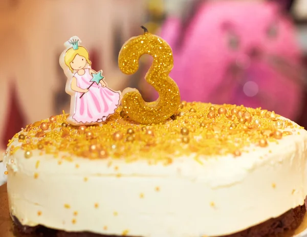 Third birthday of girl. Pink number 3 on birthday cake with princess. Happy birthday celebration party, copy space.