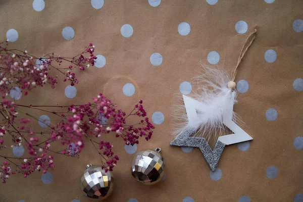 Trendy Christmas decorations with disco balls and pink gypsophila flower. Christmas festive background with basic classic pattern. Aesthetic atmosphere. Merry Christmas and home coziness concept.