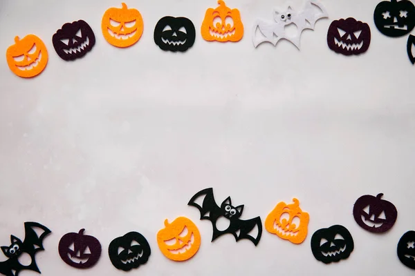 Happy Halloween decorations with bats, cute pumpkins. View from above. Minimalistic holiday concept. Copy space for text. Happy Halloween, trick or treat concept. High quality photo