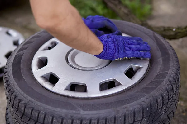 Changing of tires on the car with tools close up. Seasonal work. Safety concept.