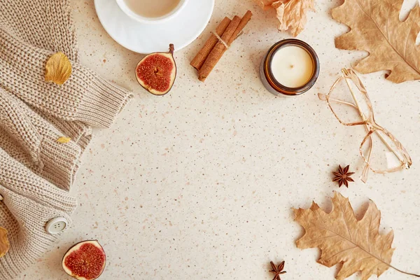Feminine autumn cozy home lifestyle background - sweater, glasess. Aesthetic coffee time among oak leaves, figs, cinnamon sticks. Copy space