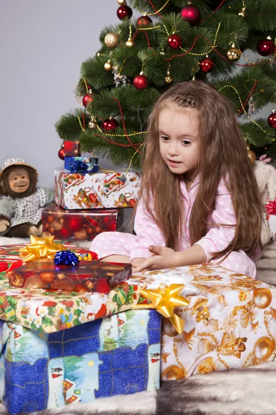 Dívka s dárkem pod vánoční stromeček — Stock fotografie