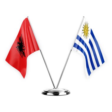 Two table flags isolated on white background 3d illustration, albenia and uruguay