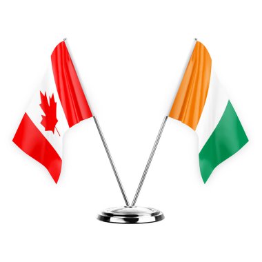 Two table flags isolated on white background 3d illustration, canada and ivory coast