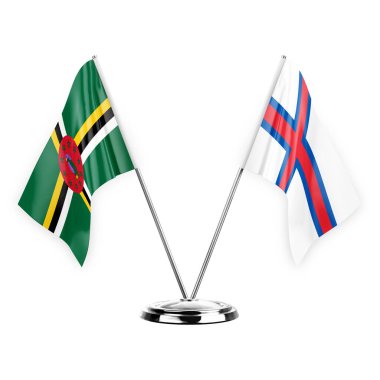 Two table flags isolated on white background 3d illustration, dominica and faroe islands