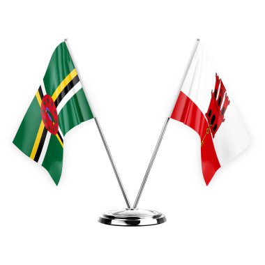 Two table flags isolated on white background 3d illustration, dominica and gibraltar