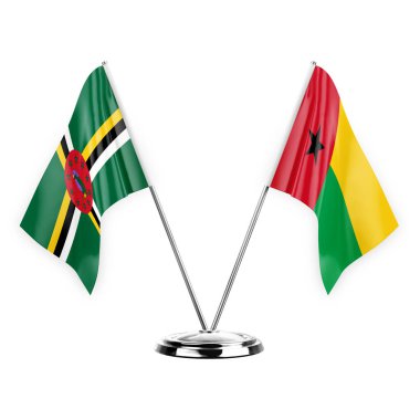 Two table flags isolated on white background 3d illustration, dominica and guinea-bissau