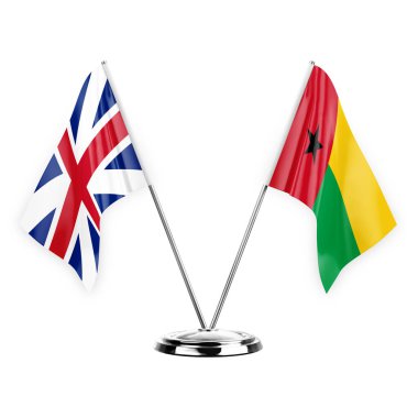 Two table flags isolated on white background 3d illustration, great britain and guinea-bissau