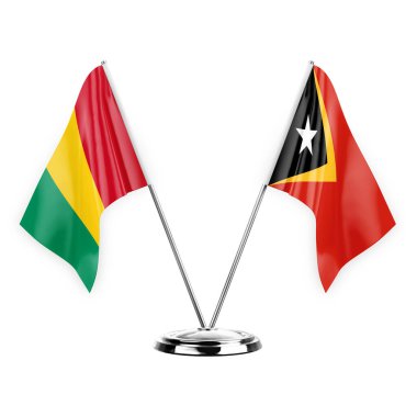 Two table flags isolated on white background 3d illustration, guinea and timor leste