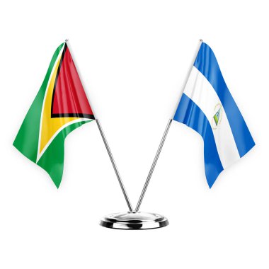 Two table flags isolated on white background 3d illustration, guyana and nicaragua