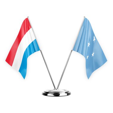 Two table flags isolated on white background 3d illustration, luxembourg and micronesia