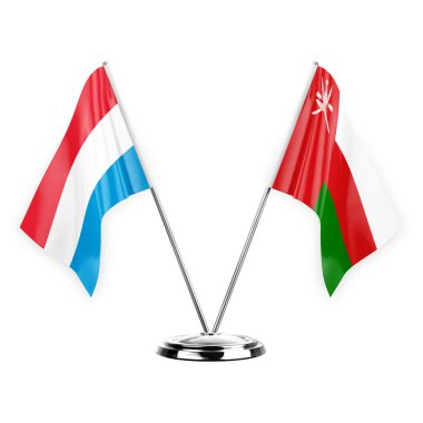 Two table flags isolated on white background 3d illustration, luxembourg and oman