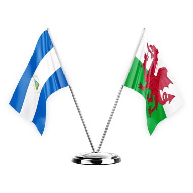 Two table flags isolated on white background 3d illustration, nicaragua and wales