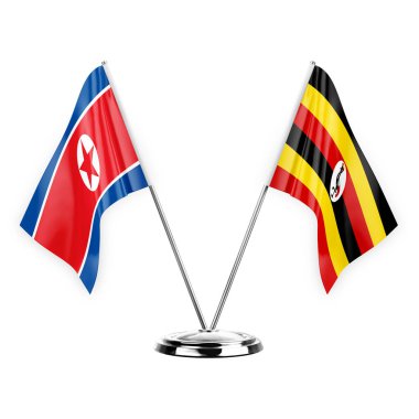 Two table flags isolated on white background 3d illustration, north korea and uganda