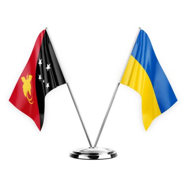 Two table flags isolated on white background 3d illustration, papua new guinea and ukraine