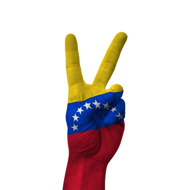 Hand making victory sign, venezuela painted with flag as symbol of victory, win, success - isolated on white background