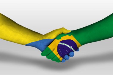 Handshake between brazil and ukraine flags painted on hands, illustration with clipping path.