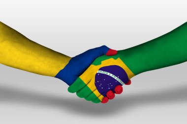 Handshake between brazil and columbia flags painted on hands, illustration with clipping path.