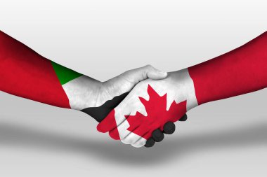 Kanada ve Birleşik Arap Emirlikleri arasındaki el sıkışma ellerinde boyanmış bayraklar, kırpma yolu olan resimler.