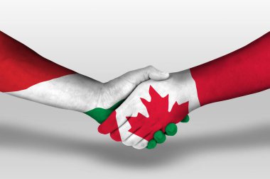 Ellerinde Kanada ve Hungary bayrakları arasında tokalaşma, kırpma yolu olan resimler.