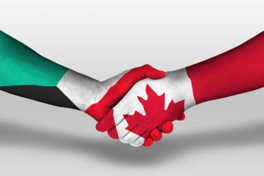 Handshake between canada and kuwait flags painted on hands, illustration with clipping path.