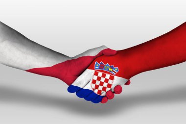 Handshake between croatia and poland flags painted on hands, illustration with clipping path.