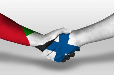 Handshake between finland and united arab emirates flags painted on hands, illustration with clipping path.