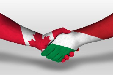 Handshake between hungary and canada flags painted on hands, illustration with clipping path.
