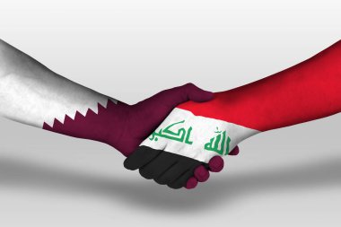 Handshake between iraq and qatar flags painted on hands, illustration with clipping path.