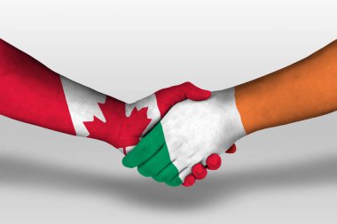 Handshake between ireland and canada flags painted on hands, illustration with clipping path.