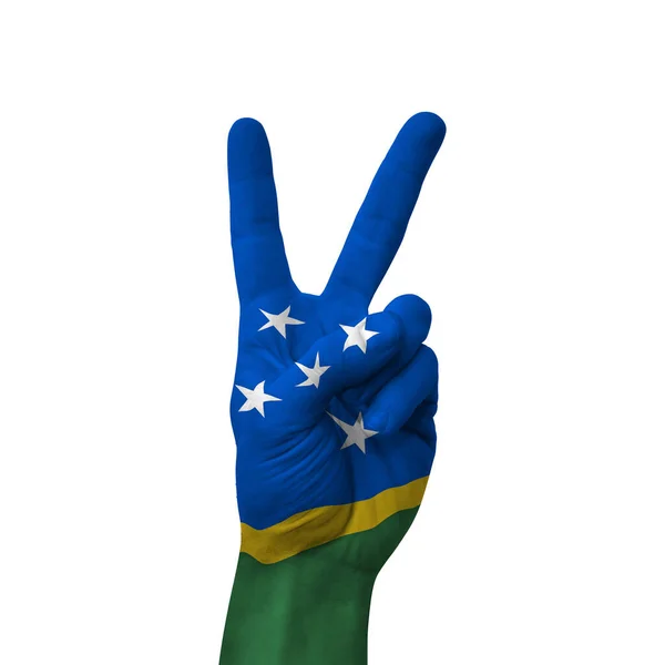 stock image Hand making victory sign, solomon islands painted with flag as symbol of victory, win, success - isolated on white background