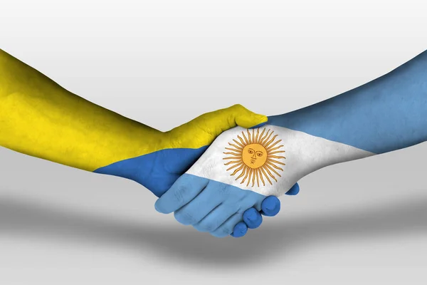 在手绘上阿根廷国旗和乌克兰国旗之间的握手 用裁剪路径说明 — 图库照片