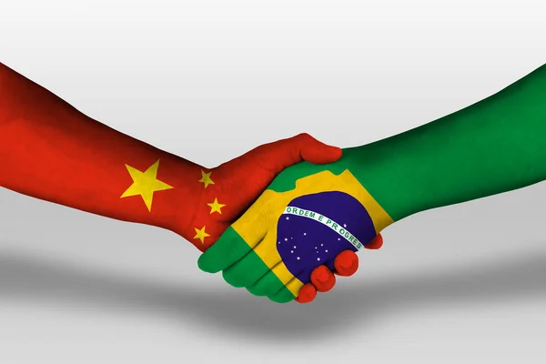 Handshake between brazil and china flags painted on hands, illustration with clipping path.