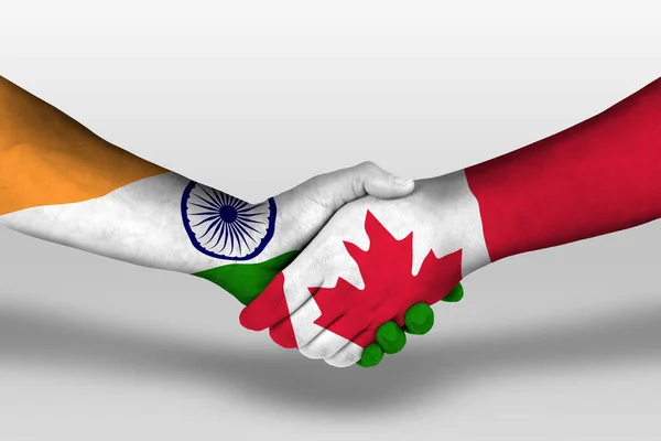 Handshake between canada and india flags painted on hands, illustration with clipping path.